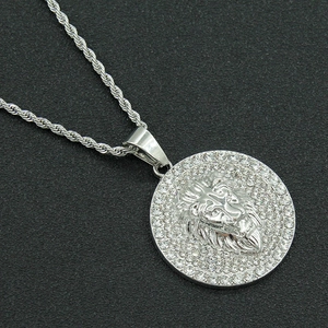 Detailed macro view of silver lion head pendant with sparkling pavé rhinestones
