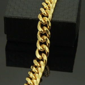 Close-up of a high-polish golden Cuban link chain with detailed metal texture