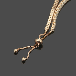 Detail of rose gold tennis bracelet with square zircons and adjustable slider clasp