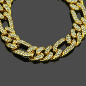 Macro view of 12mm gold plated Cuban link chain with detailed micro pavé rhinestones