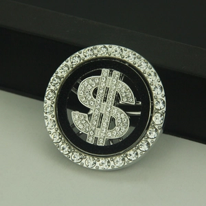 Sparkling silver dollar sign brooch with white rhinestones and a round metal frame