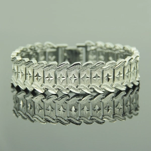 Men's silver hiphop watch-style link bracelet with engraved star patterns and textured metal