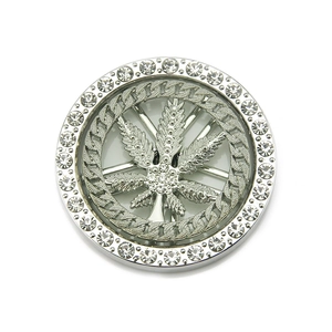 Macro detail of rotating silver maple leaf charm with sparkling crystals for DIY accessories