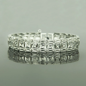 Chunky silver hip hop bracelet with geometric diamond patterns and polished finish