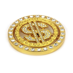 Close-up of a rotating gold dollar sign pendant with sparkling rhinestones for DIY crafts