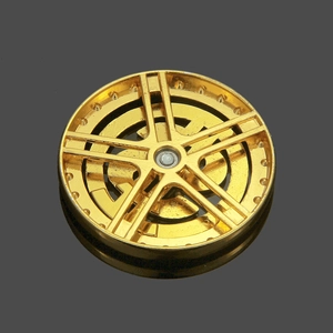 Close-up of golden five-spoke spinning wheel charm accessory for DIY phone cases
