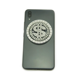 Silver spinning dollar sign phone ring holder with rhinestones on a smartphone