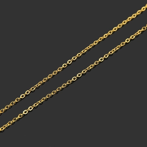 Close-up of golden stainless steel cross chain with polished metal links and reflections
