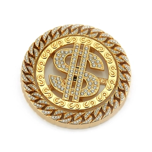 Macro shot of gold hip hop dollar sign charm with sparkling crystals and Cuban chain texture