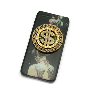 Golden dollar sign phone socket with rhinestones on black case, 45-degree angle view