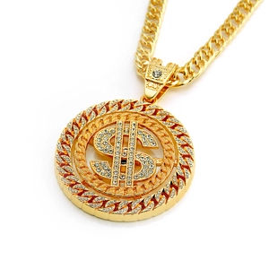 Macro detail of gold-tone hip-hop pendant necklace with iced-out dollar sign and cuban chain
