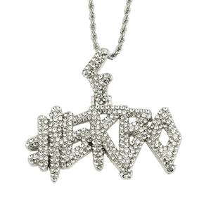 Close-up of iced-out hip-hop letter pendant with sparkling rhinestones and rope chain