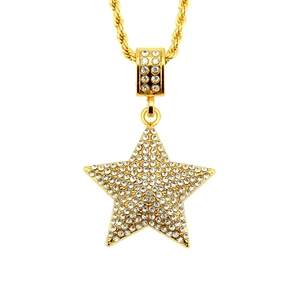 Macro shot of hip hop star pendant with pavé crystals on a golden rope chain