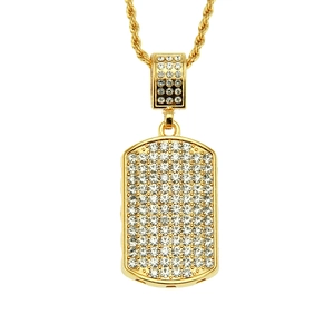 Close-up of hip hop gold dog tag pendant with rows of crystals and rope chain