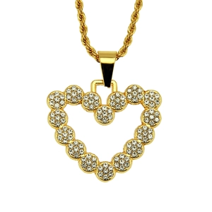 Detailed macro view of heart pendant with sparkling white rhinestones on golden rope chain
