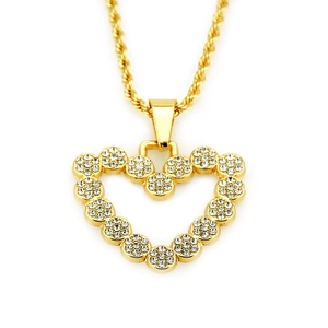 Detailed macro view of iced out heart pendant necklace with gold plated rope chain
