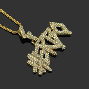 Iced out hip hop letter pendant necklace with gold rope chain on black background