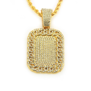 Close-up of iced out hip hop rectangle pendant with gold rope chain and sparkling crystals