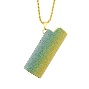 Detailed view of a gradient glitter lighter pendant on a gold twisted chain necklace