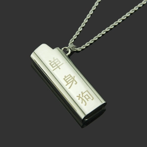 Macro view of silver metal lighter case necklace with creative Chinese engraving