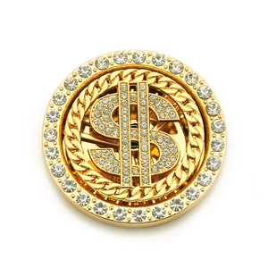 Detailed close-up of a rotating gold dollar sign accessory with sparkling crystals