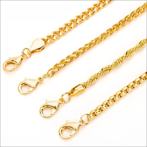 Macro detail of four gold-plated hip hop style jewelry chains with lobster clasps