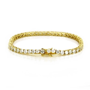 Macro shot of 18K gold plated tennis bracelet featuring round cubic zirconia and safety clasp