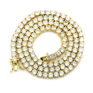 Macro view of 4mm gold tennis chain featuring micro-pave cubic zirconia and box clasp