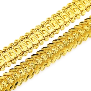 Close-up of gold hip-hop bracelets showing intricate textured links and metallic gloss