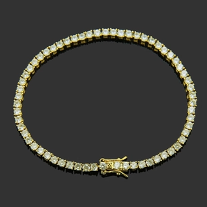 Detailed view of gold tennis bracelet with cubic zirconia on black reflective background