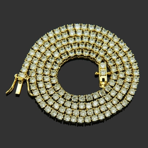 Macro shot of gold tennis chain with round cubic zirconia and secure insertion clasp