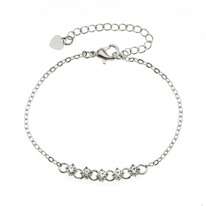 Detail of silver chain bracelet with five round cubic zirconia and heart pendant