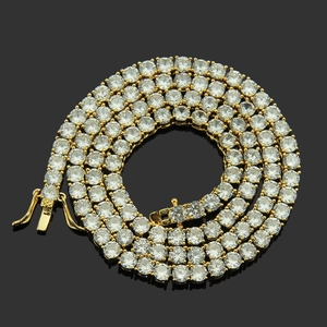 Detailed top view of gold tennis chain necklace with zircon stones on black background