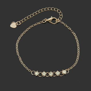 Rose gold chain bracelet featuring five sparkling crystals and a delicate heart charm