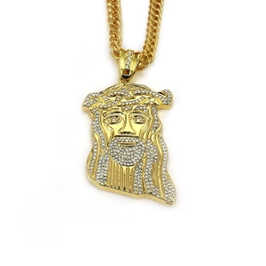 Detail of hip hop Jesus pendant with cubic zirconia and chunky golden Cuban link chain