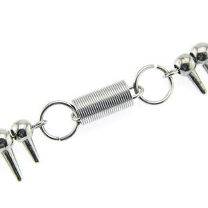 Macro detail of punk wallet chain featuring metal spring and silver spiked pendant