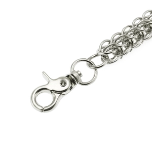Close-up of a silver metal pants chain featuring a swivel lobster clasp and link texture