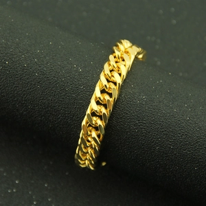 Polished golden cuban link chain ring for men with hip hop style on black stand