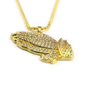 Close-up of hip hop gold praying hands pendant with pavé cubic zirconia on square box chain