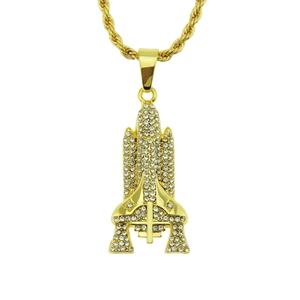 Close-up of golden rocket pendant with white rhinestones on a twisted rope chain