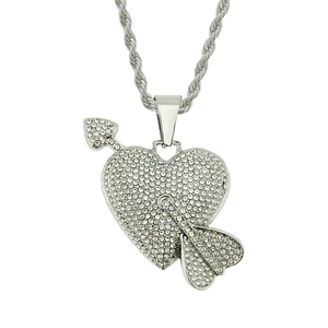 Close-up of iced out heart and arrow pendant with silver rope chain and clear rhinestones