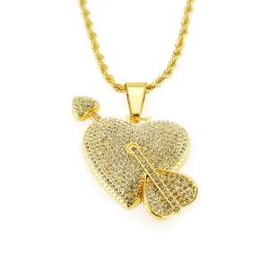 Macro shot of gold-plated heart pendant with arrows and sparkling pave-set rhinestones