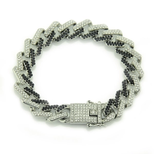 Macro shot of Cuban chain bracelet featuring alternating black and white pavé rhinestones