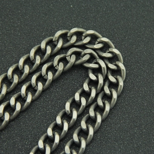 Macro view of matte silver Cuban link chain with thick metal loops in industrial style