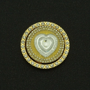 Rotating golden heart pendant with layered crystals and large central rhinestone heart