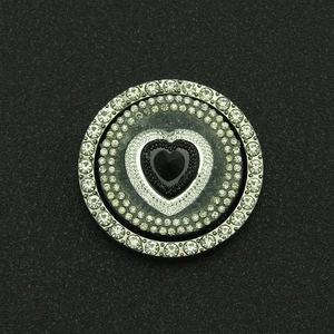 Detail of rotating heart-shaped rhinestone charm with black crystal and silver base