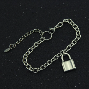 Detailed close-up of a silver chain bracelet with a polished padlock pendant on black background