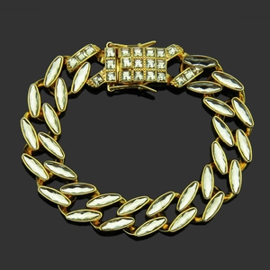 Detail of gold-tone Cuban link bracelet with sparkling marquise-cut crystals in hip hop style