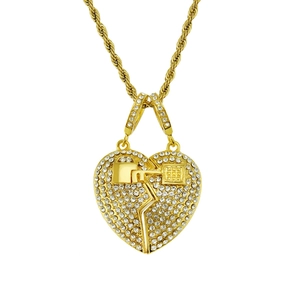 Close-up of gold iced out broken heart magnet pendant with sparkling rhinestones