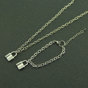 Silver padlock pendant jewelry set featuring a long necklace and matching bracelet